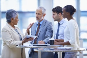 Business man signing contract paper during corporate meeting